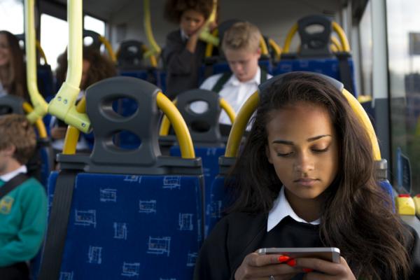Young girl using a smartphone on the bus
