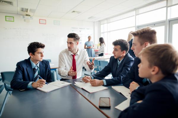 school teacher sitting with children