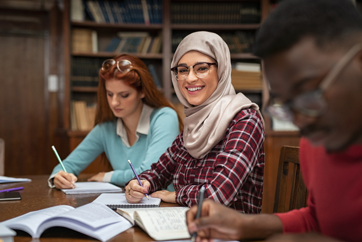 Group of people working at a table in a library