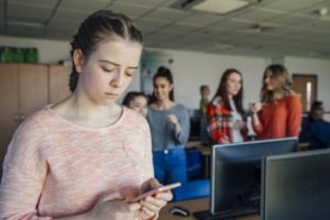 Worried girl looking at phone