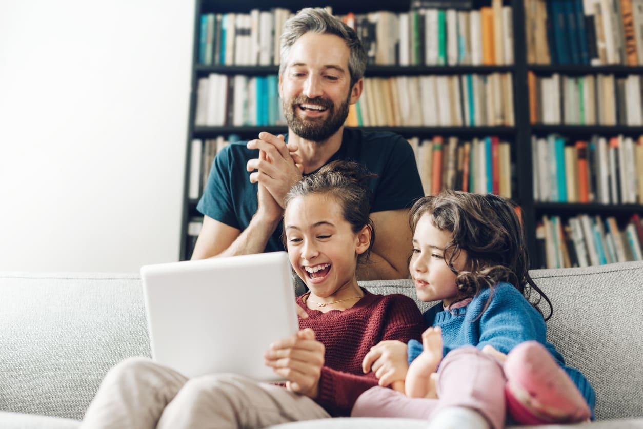 Foster family reading on sofa