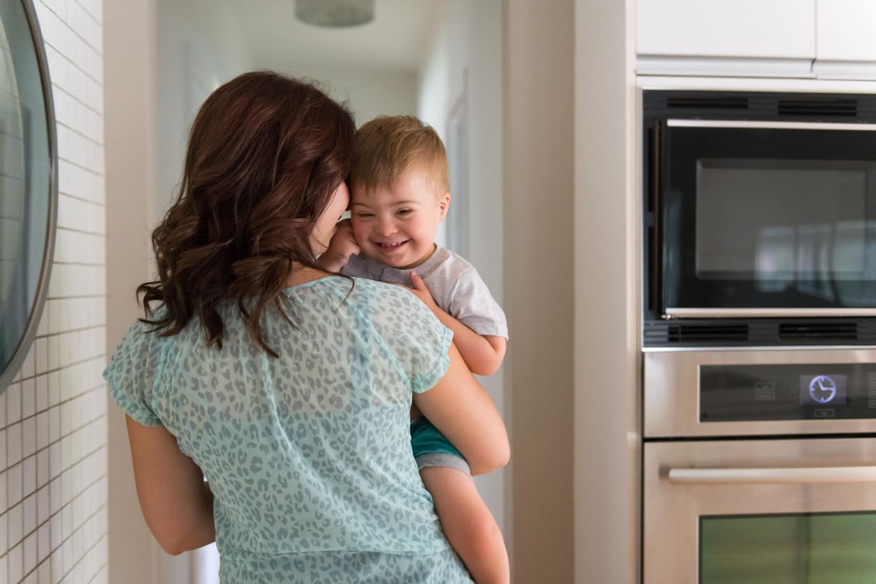 Three years old little boy with Down Syndrome with his mom