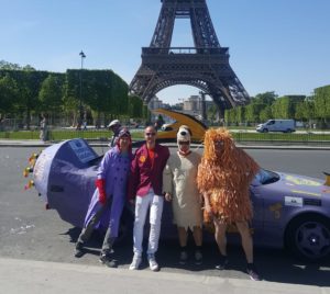 People in costume in front of car