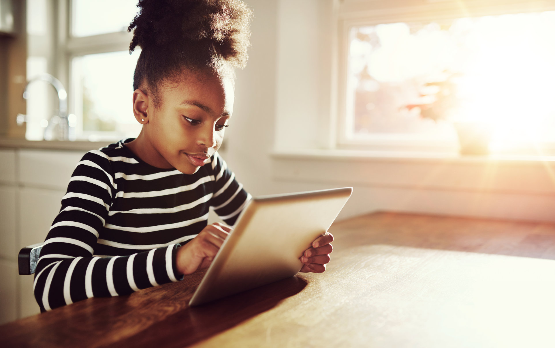 young girl browsing on tablet