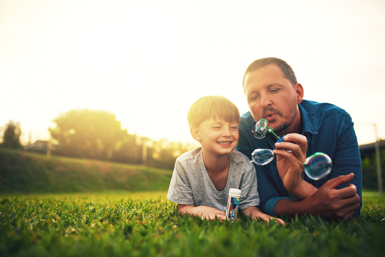 Foster Carer with foster child blowing bubbles