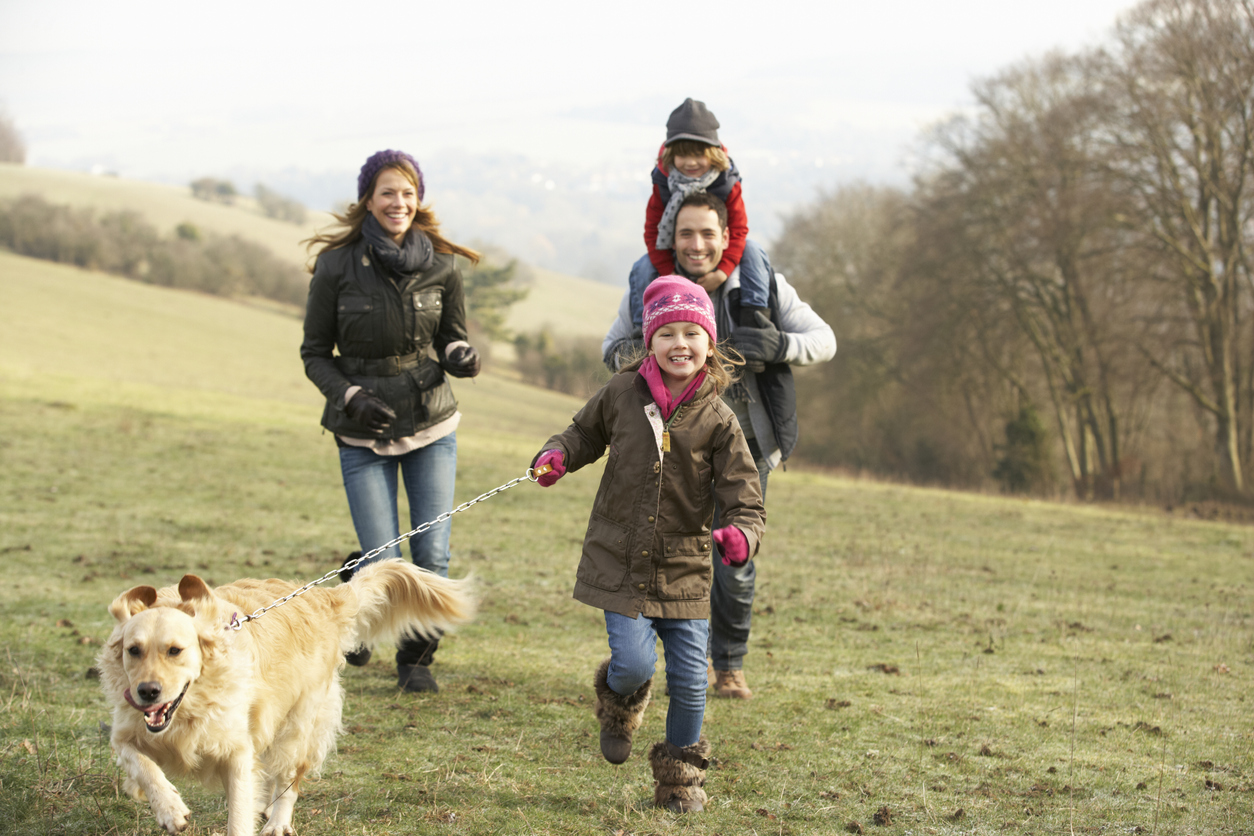 Foster family and dog on country walk in winter