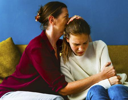 Woman comforting teenager