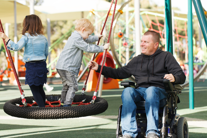 Disabled foster carer with foster child at the park