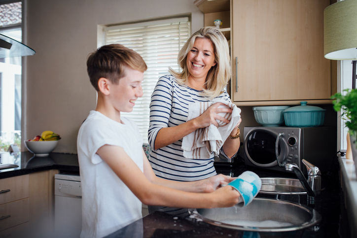 Mother and son doing dishes