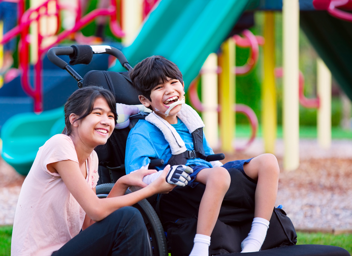 siblings sitting together in park