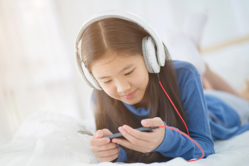 Girl on phone with headphones