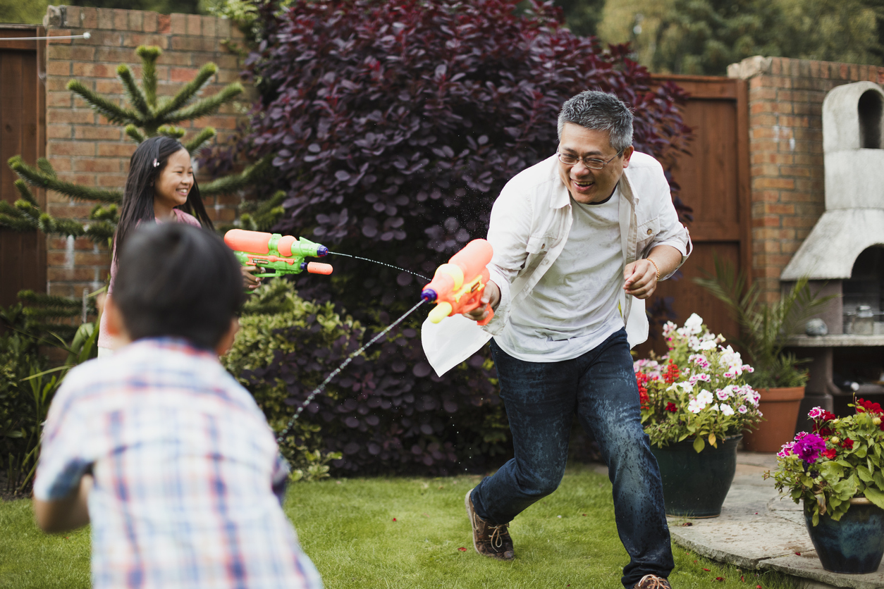 Foster family having a water fight
