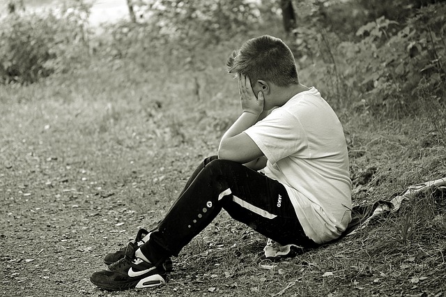 Teen boy sitting alone