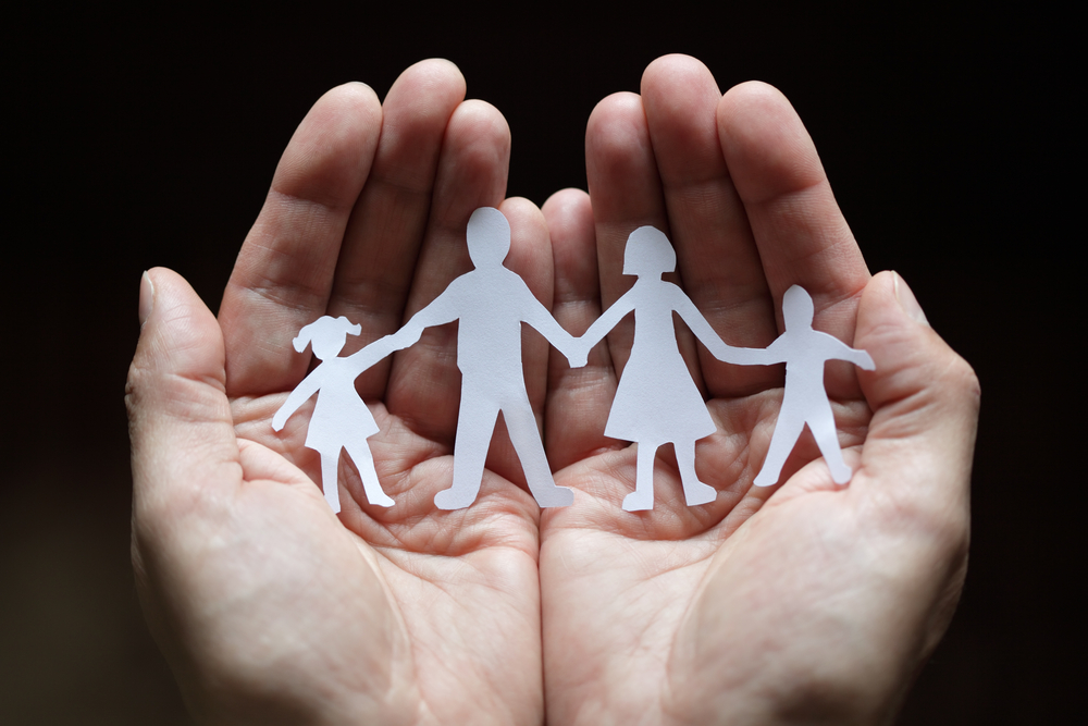 hands_holding_paper_cutout_family.jpg