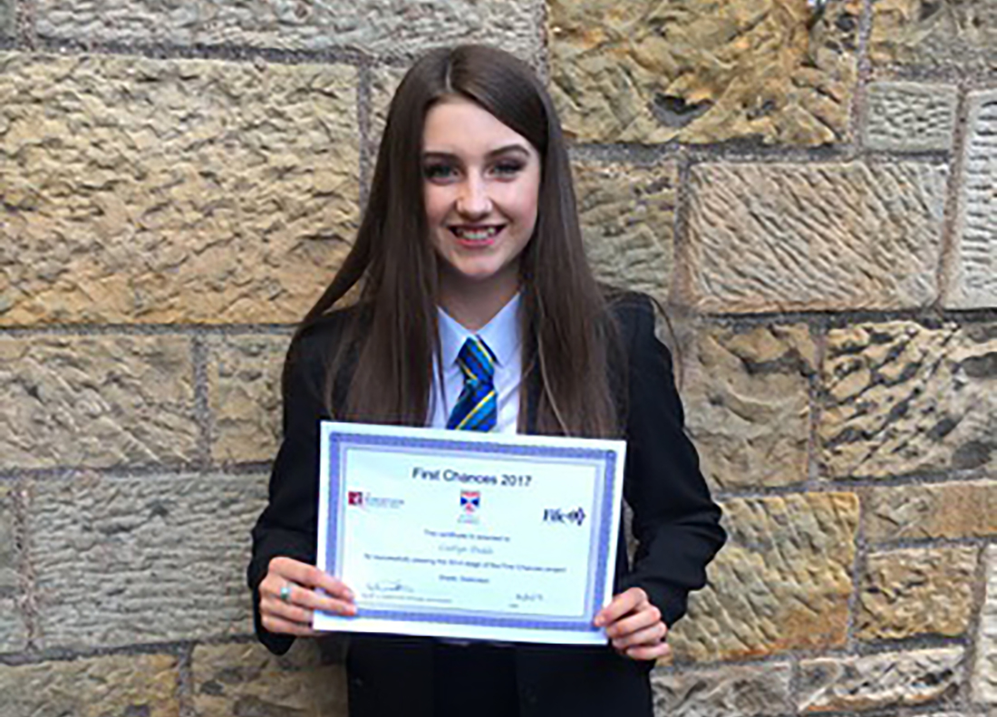 Caitlyn holding her certificate