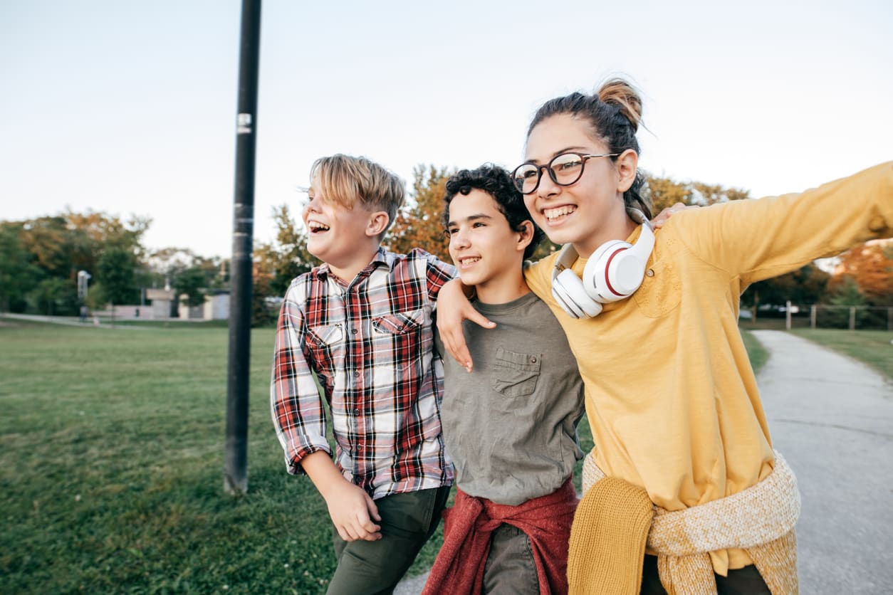 3 children in park outdoors fostering