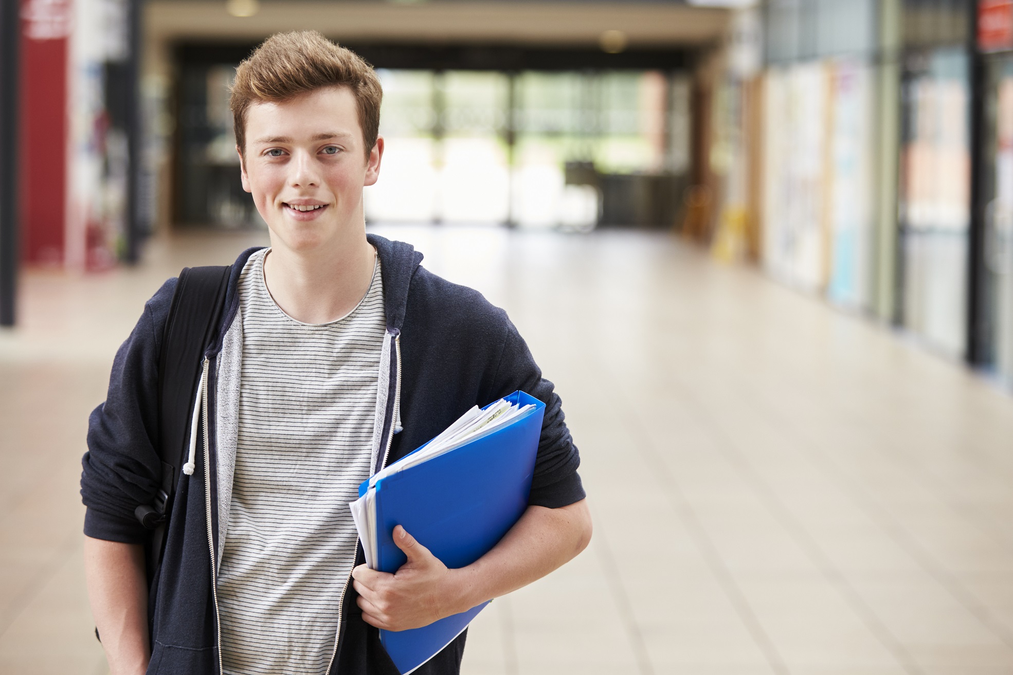 Portrait Of Male Student Standing In College Building