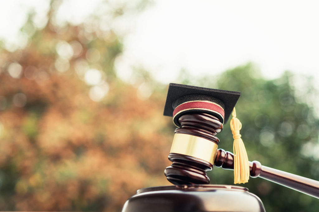 Graduation diploma hat and judge gavel