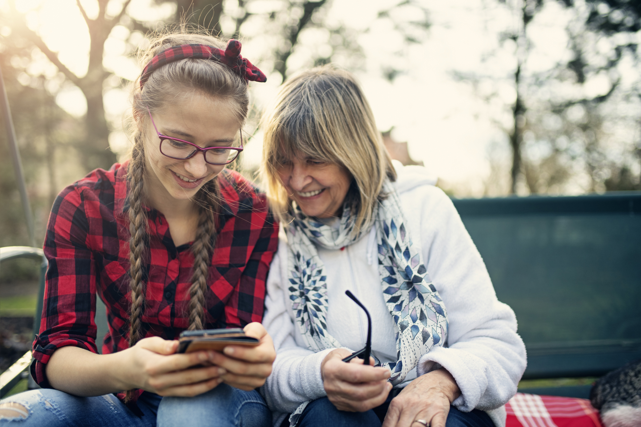 foster parent and teen girl looking at phone