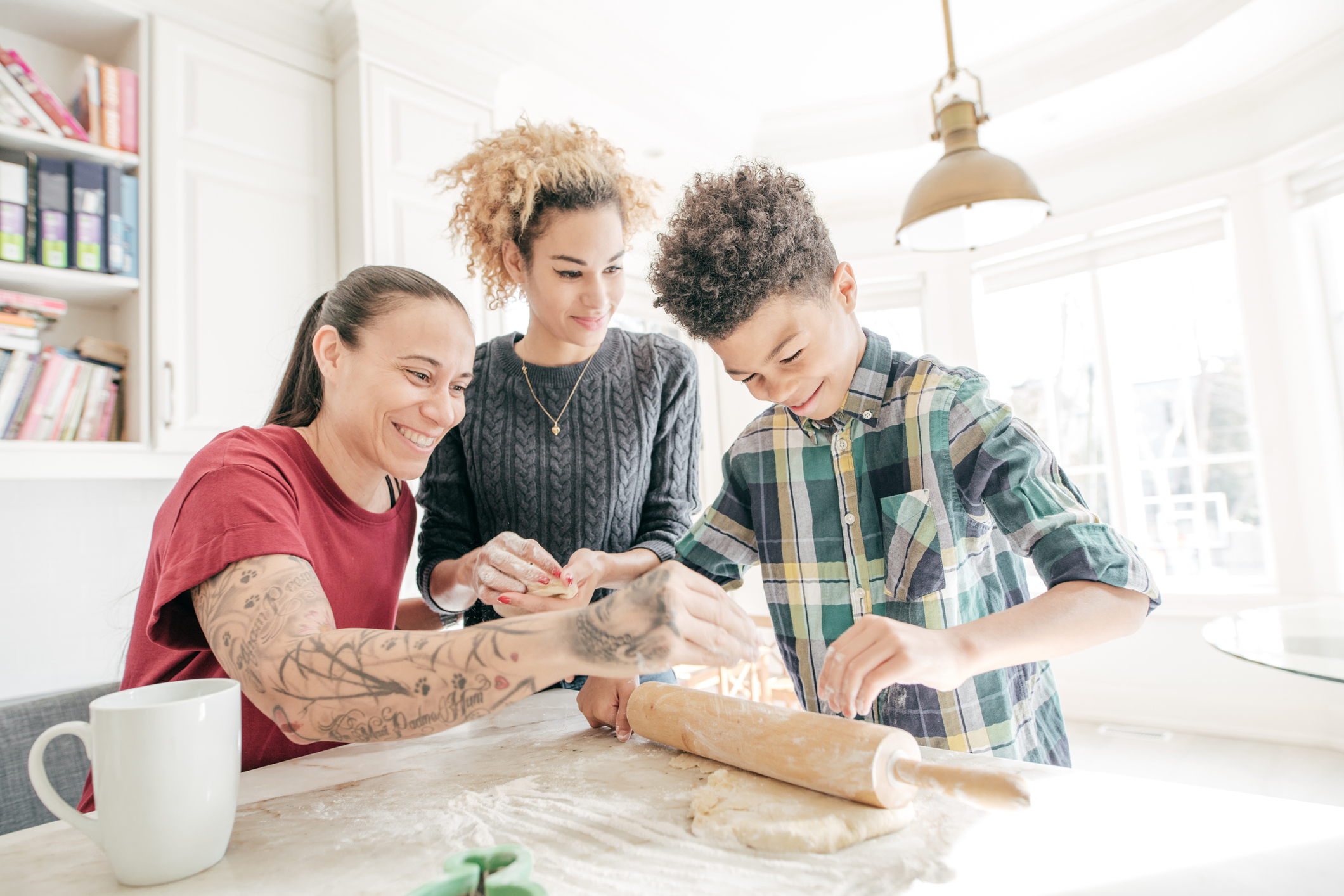 Young female couple with young boy baking