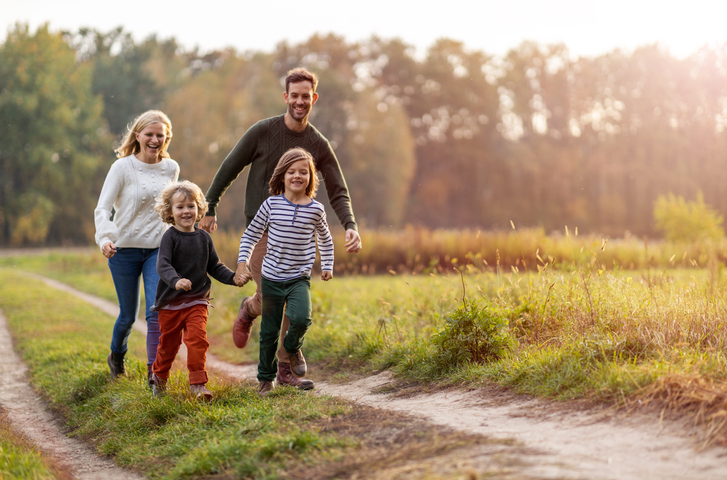 Foster family walking in countryside