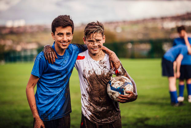 Teenagers playing football