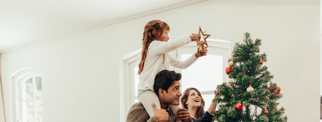 Jane and foster family decorating Christmas tree