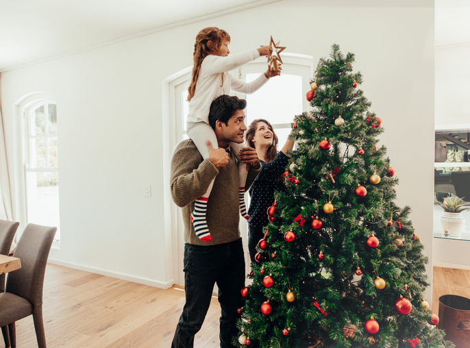 Jane and foster family decorating Christmas tree
