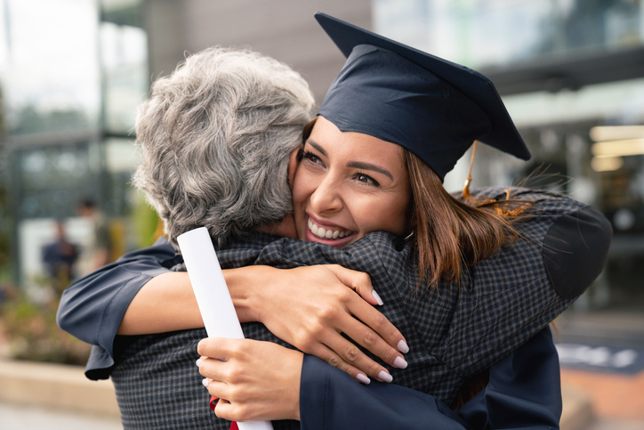 Graduate Heather hugging foster carer Brian