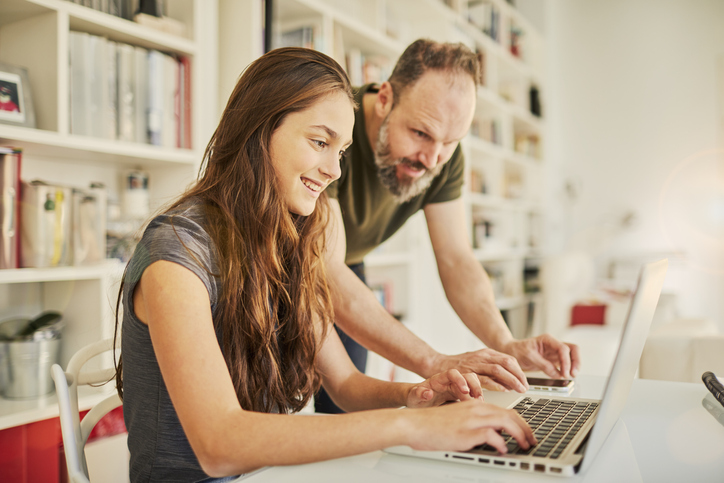 Foster carer Brian helping foster child with homework