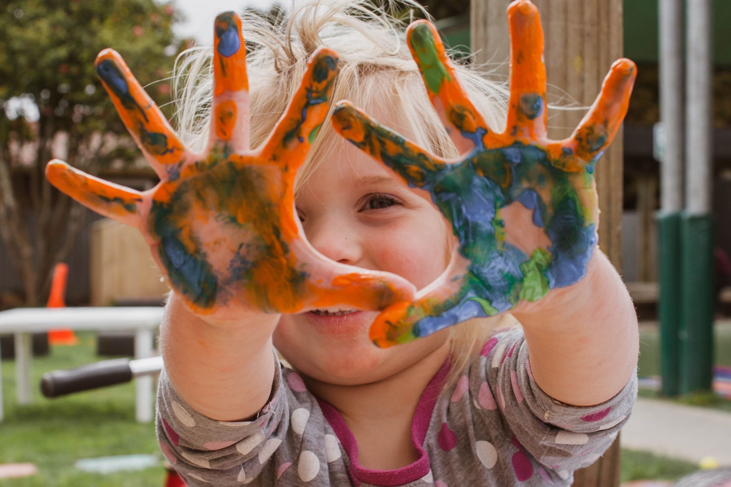 Young girl with paint on hands