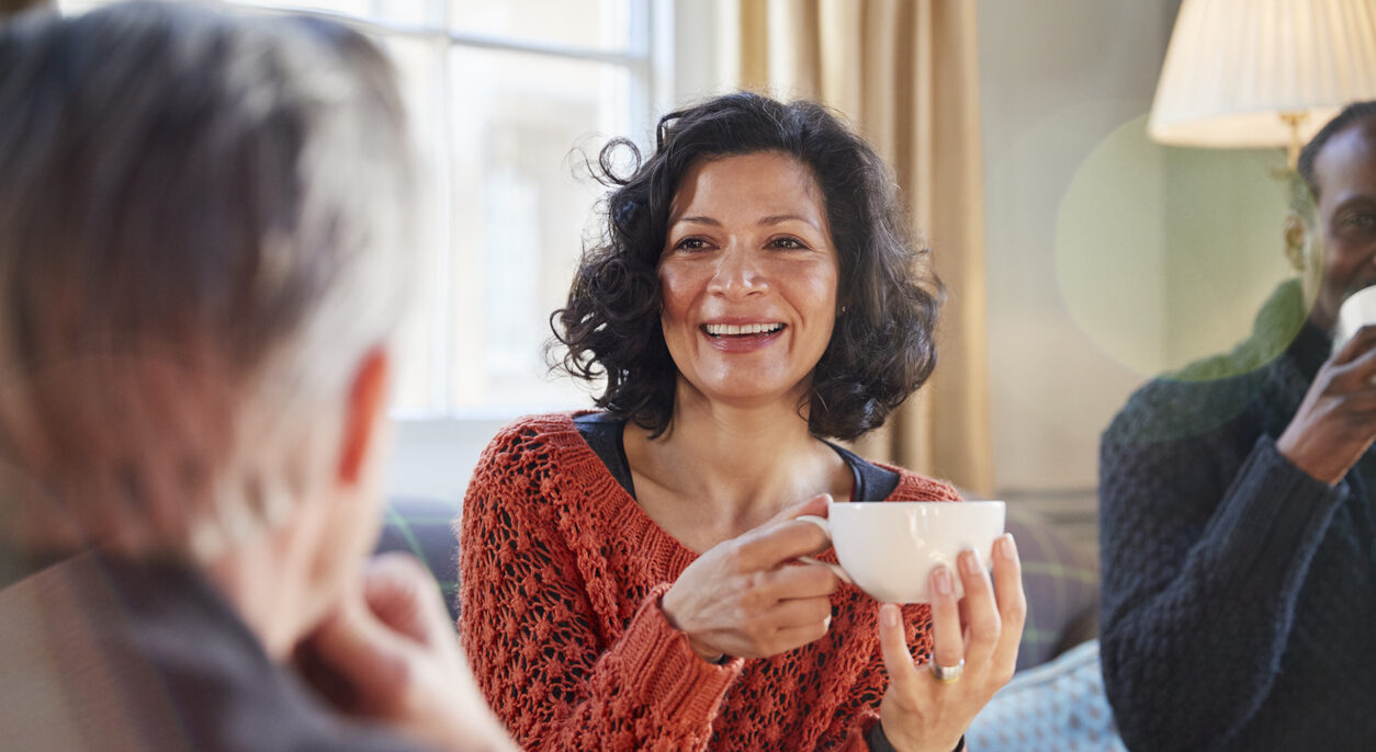 Social worker talks to a potential foster carer over a cup of tea