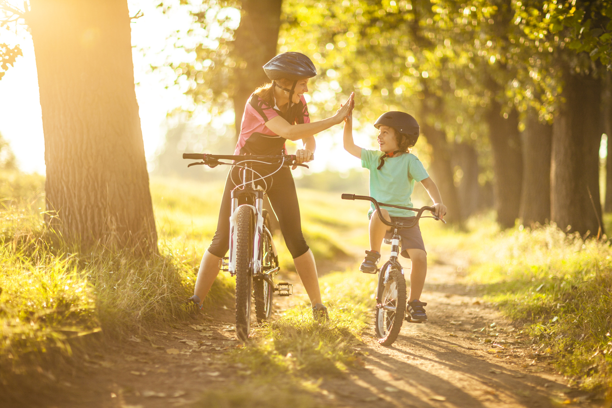 Foster carer and foster child riding a bike