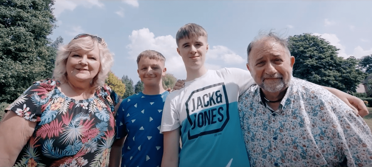 Leicestershire foster carer Nick (right) with his wife Petrina and foster children Sam and Mason, in a screen capture from our latest video (see below)